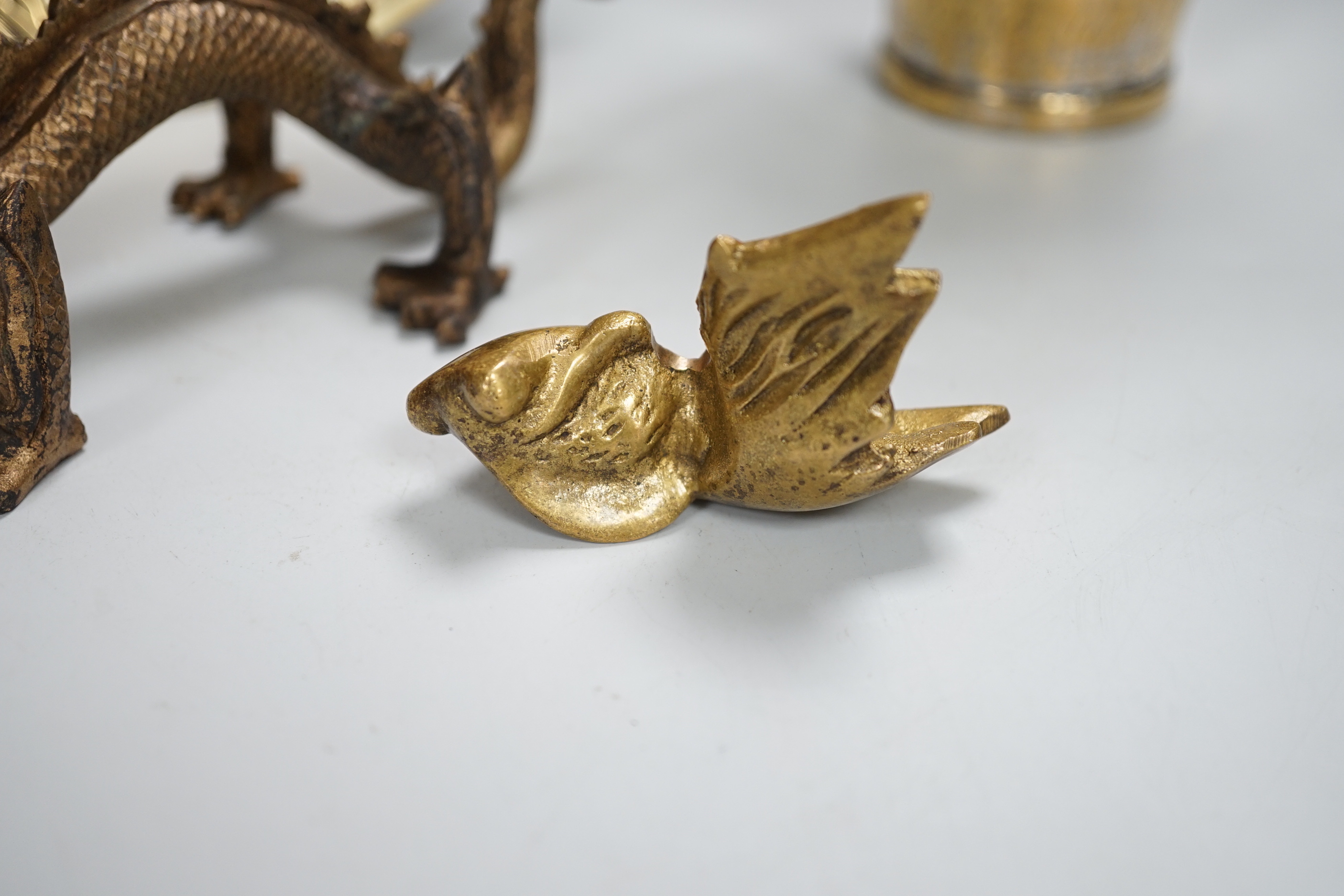 A Chinese engraved brass plate, large engraved beaker, koi fish and a dragon, the largest 24cm in diameter